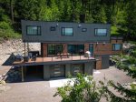 This beautifully modern home offers quick access to Whitefish Lake in a peaceful treetop setting.